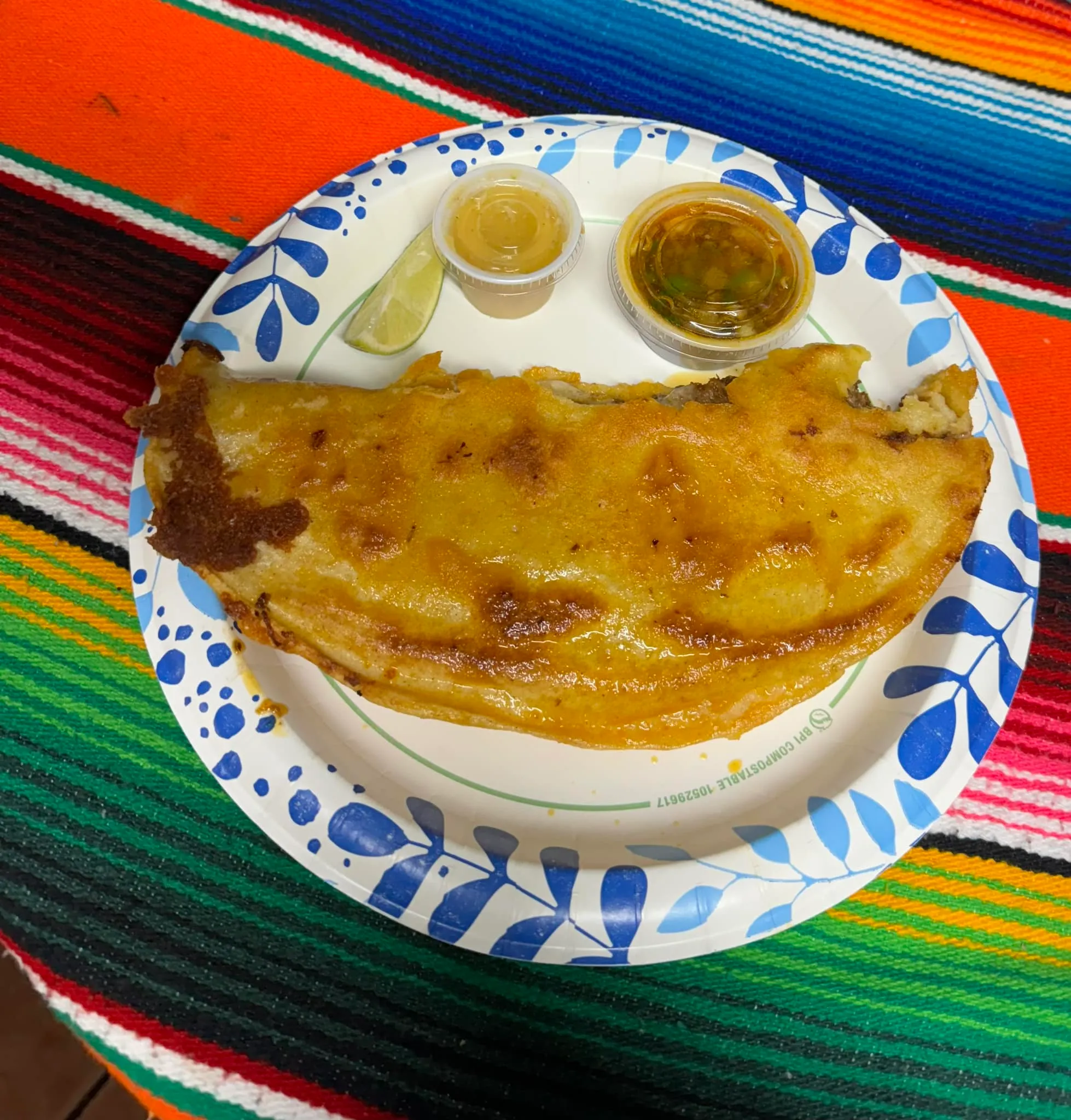 A plate of colorful food sits on a wooden table, ready to be enjoyed.