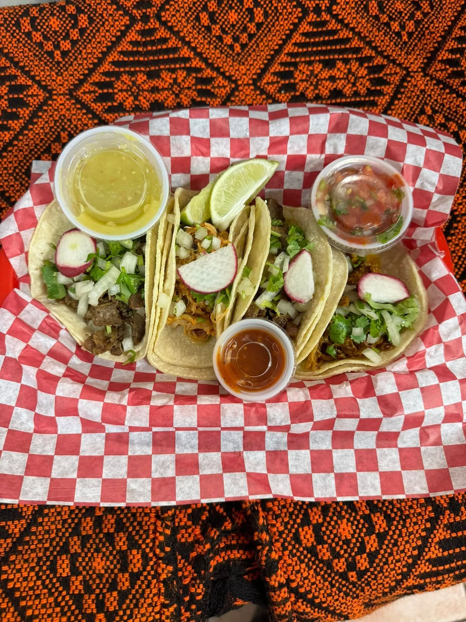 A basket of tasty tacos is displayed on a table, ready to be enjoyed.