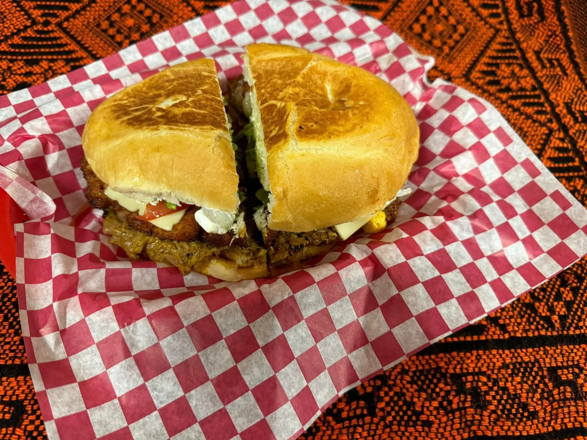 A tasty sandwich on a paper, inviting you to take a bite.
