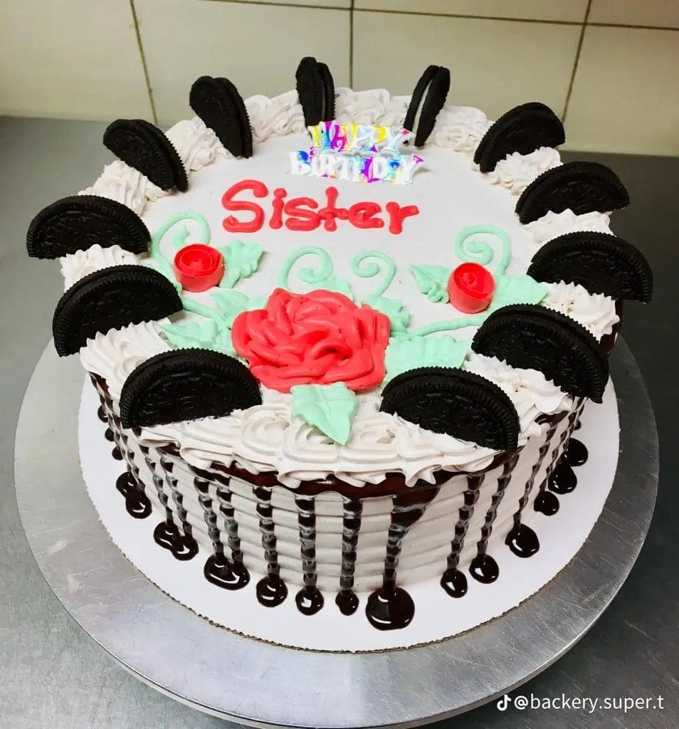 A cake decorated with the word "sister" written in icing on top