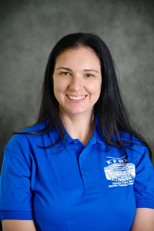 Staff member Kseniya Rojas in blue school polo