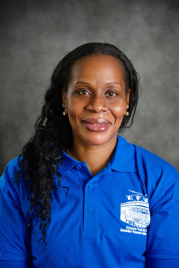 Staff portrait of Shinda Alfred in blue polo