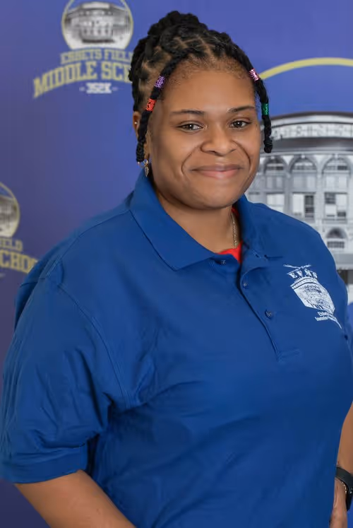 Staff member Ms. Oriel Best in blue school polo