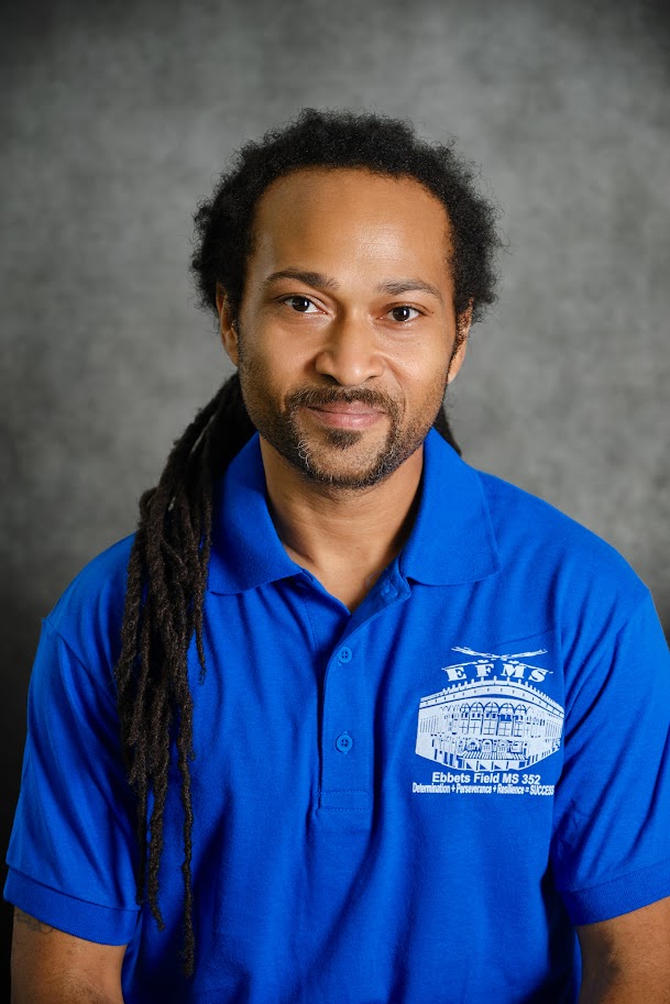 Staff member Kamau Clement in blue school polo