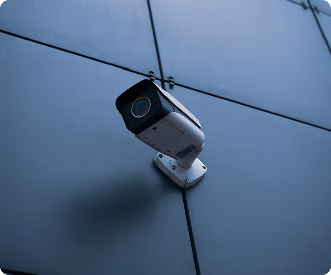a security camera attached to an outside wall