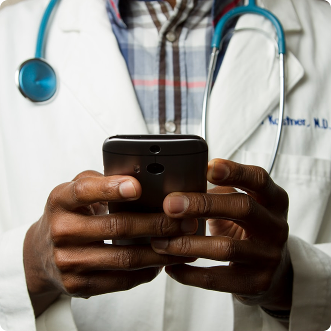 Zoomed in shot of a doctor on their phone looking at patient care