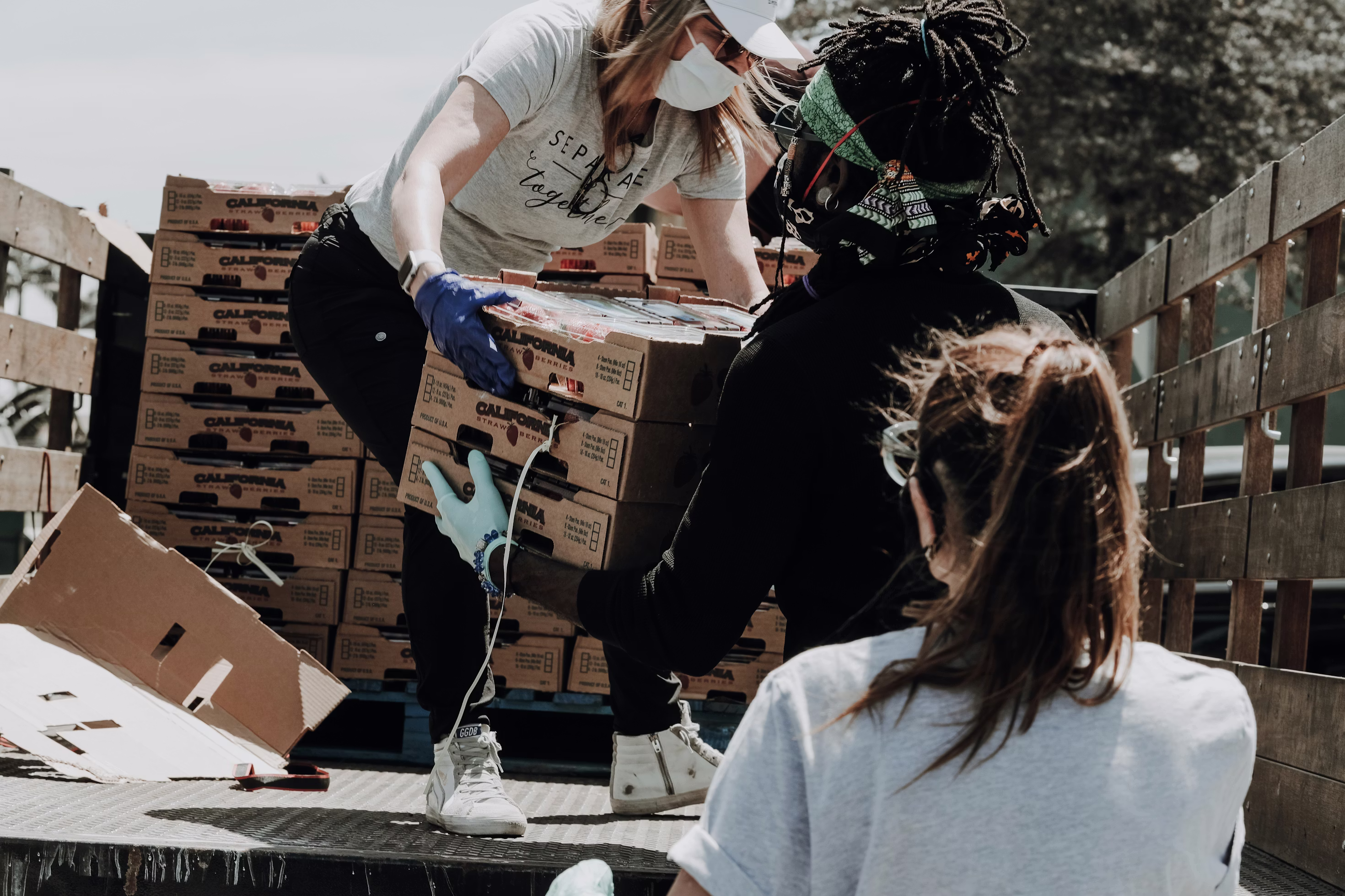 People loading food donations onto a truck to give to those in need