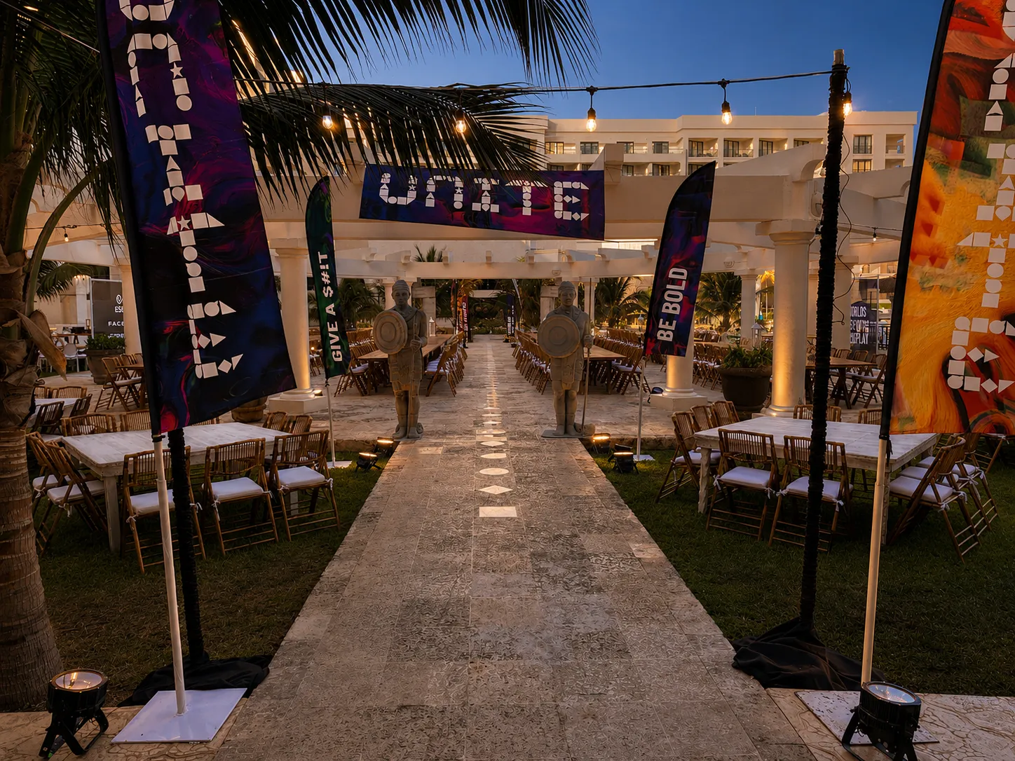 Closing celebration featuring long banquet tables and Mayan-inspired conference décor.