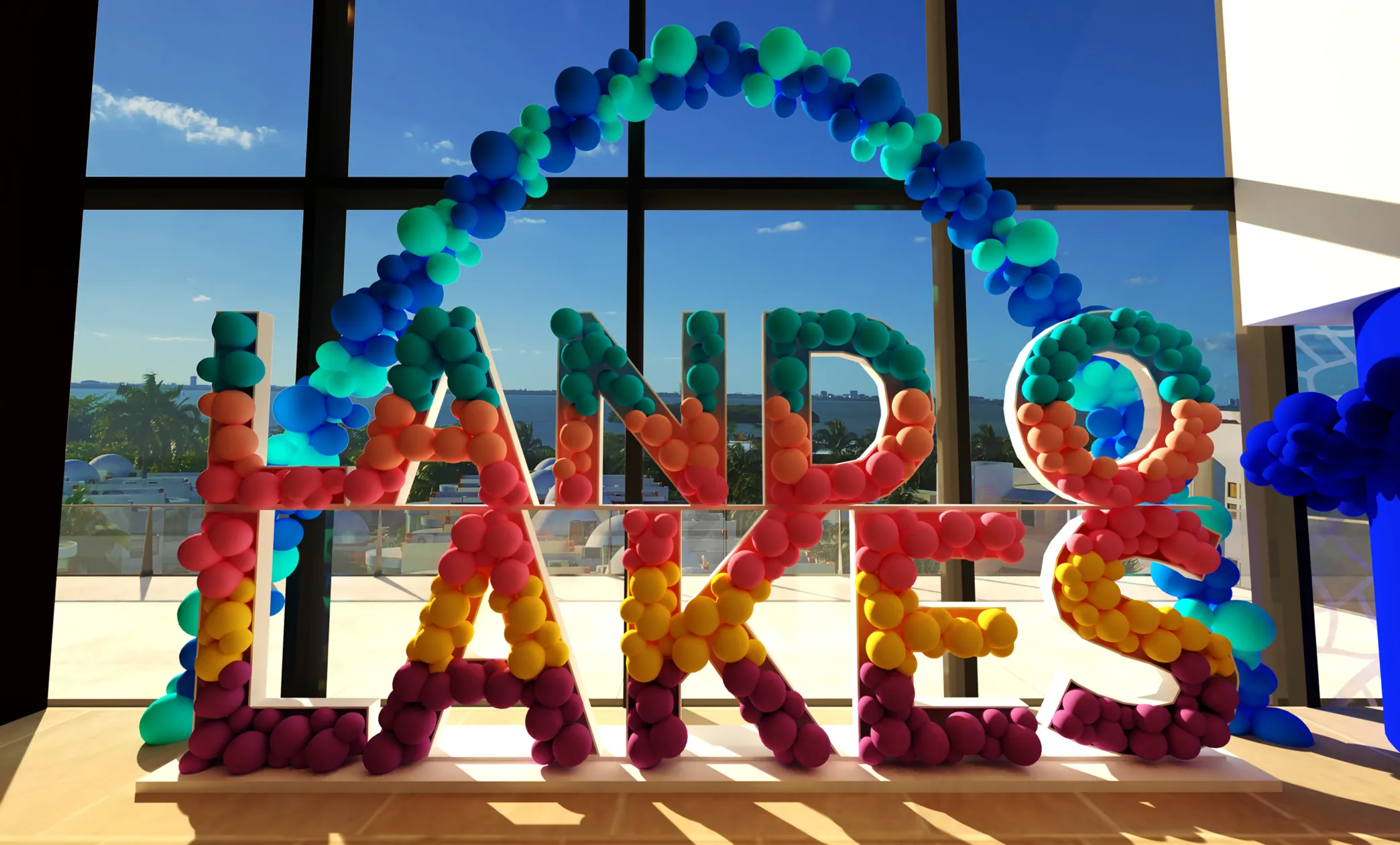 A 3D render of a balloon-filled marquee photo op lit against a window at dusk.