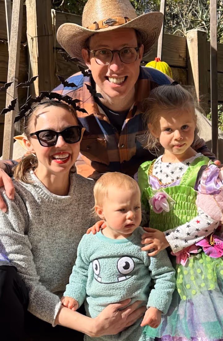 Illustration of a golden sun with a serene face surrounded by stars, symbolizing seasonal rhythm and storytelling.