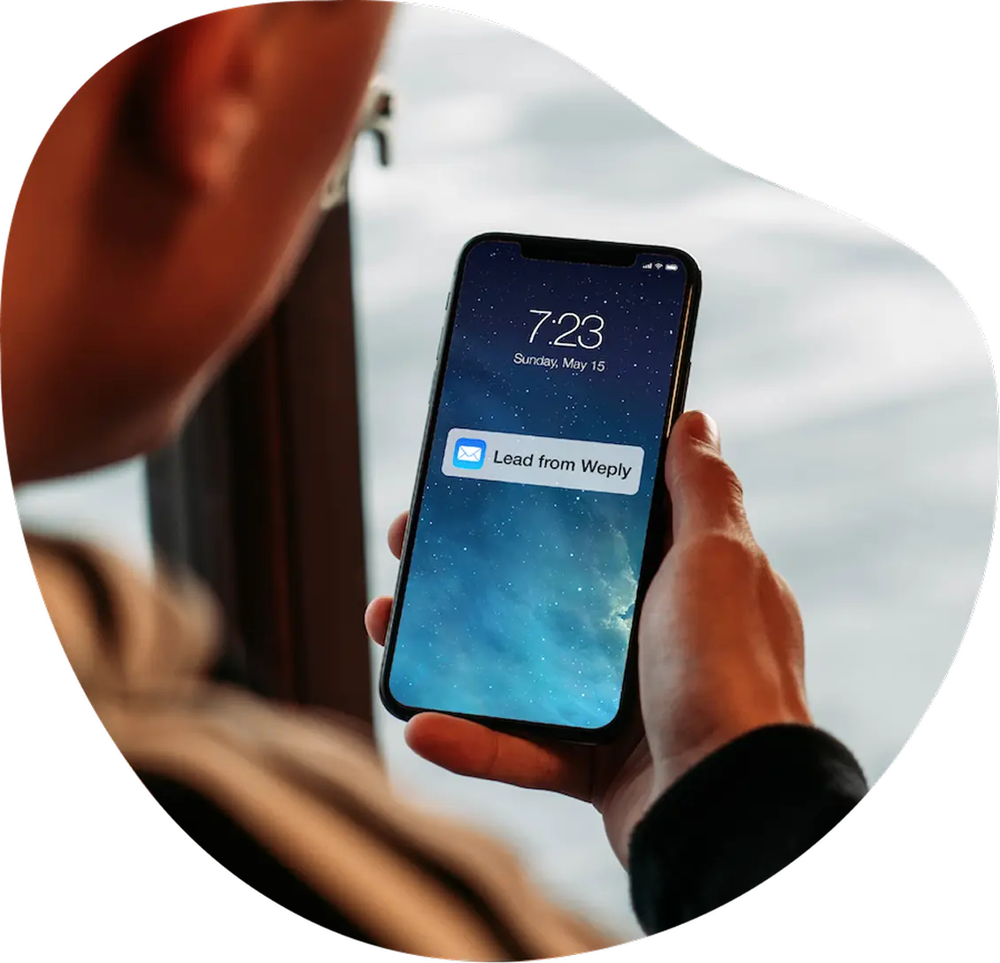 A person holding a cell phone in their hand.