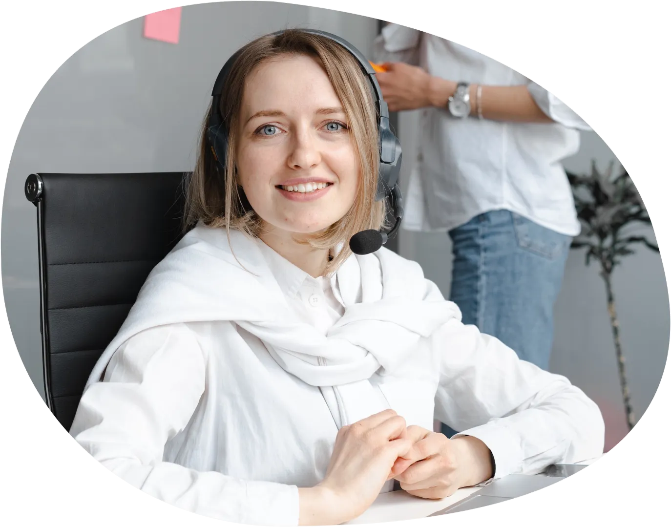 A woman sitting in front of a mirror wearing a headset.