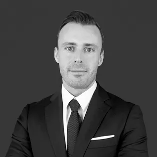 A black and white photo of a man in a suit.