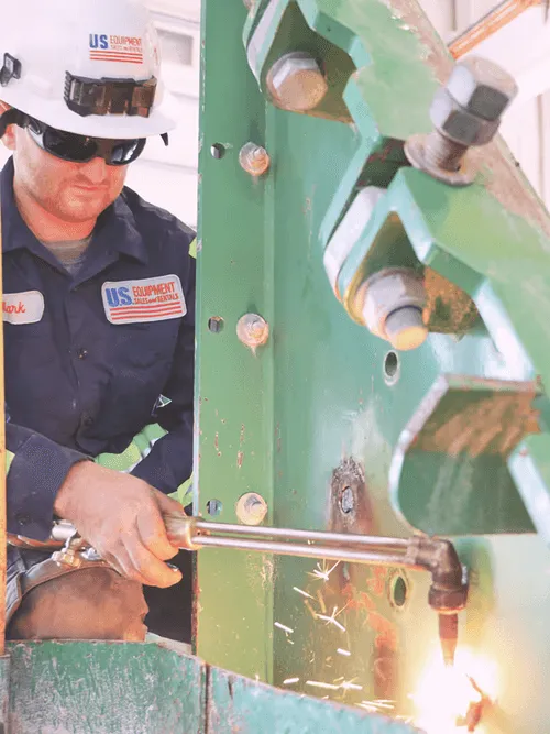A man in a hard hat working on a machine.