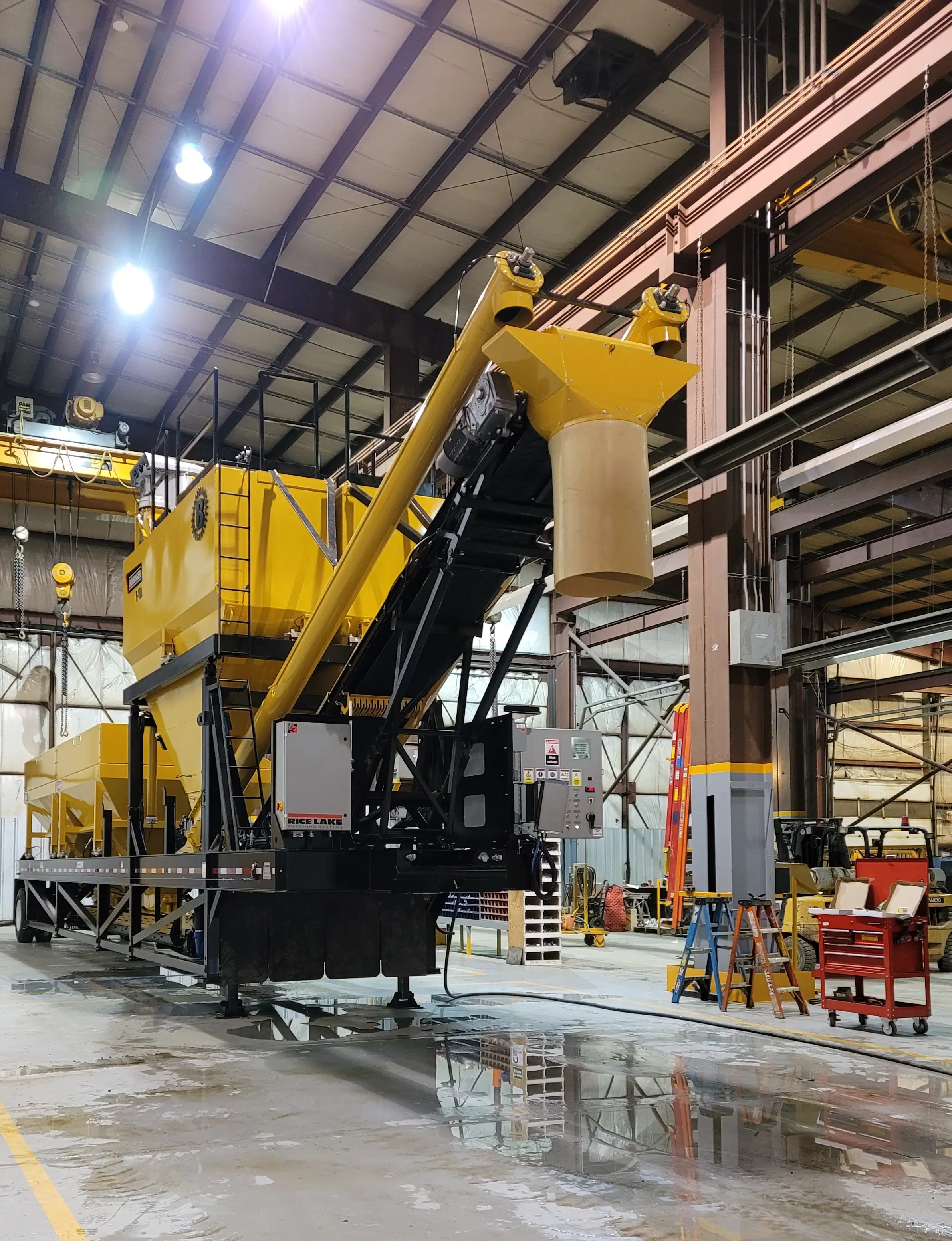 Bohringer portable processing plant inside a fabrication and assembly facility, showing conveyors, hoppers, and structural components during equipment build-out.