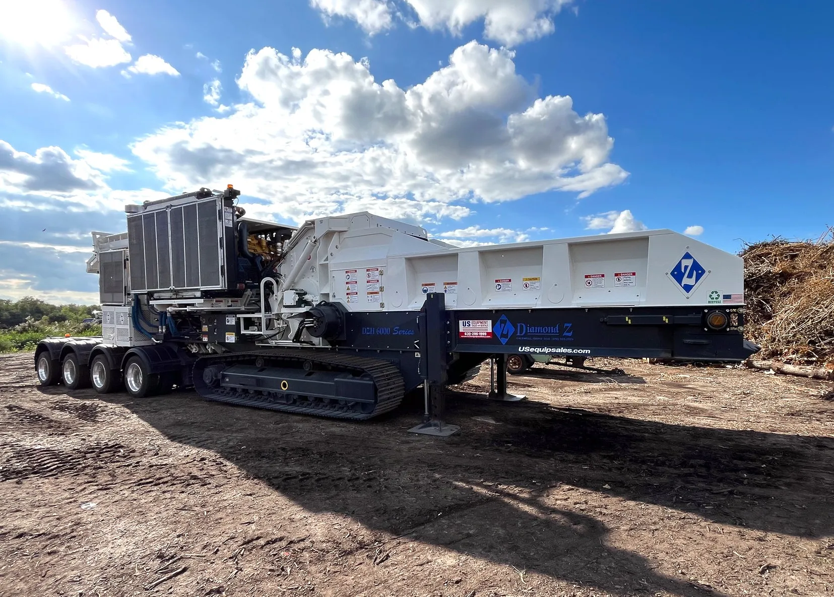 Diamond Z horizontal grinder featuring extended discharge conveyor for efficient material processing and stockpiling.