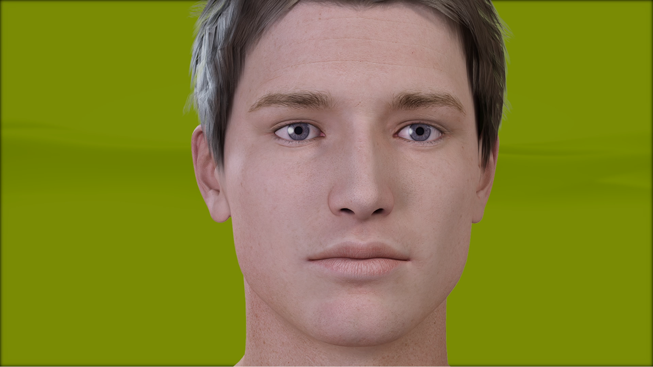 Close-up of a young man with short brown hair and blue eyes against a green background.