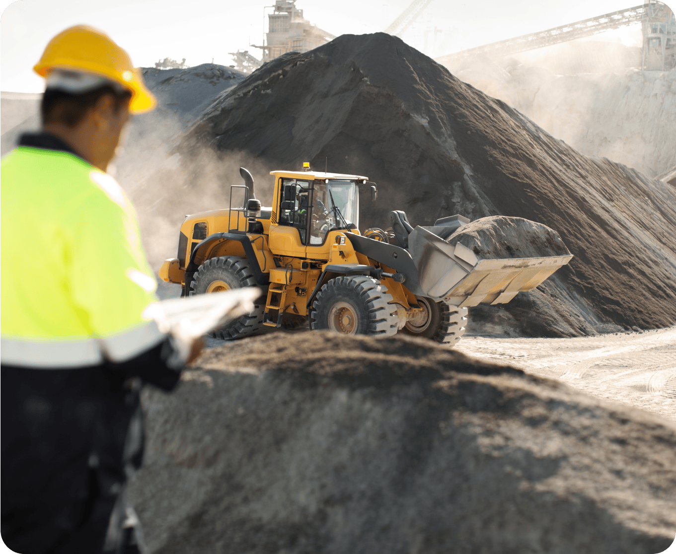 Mining site with heavy machinery operating on rocky terrain
