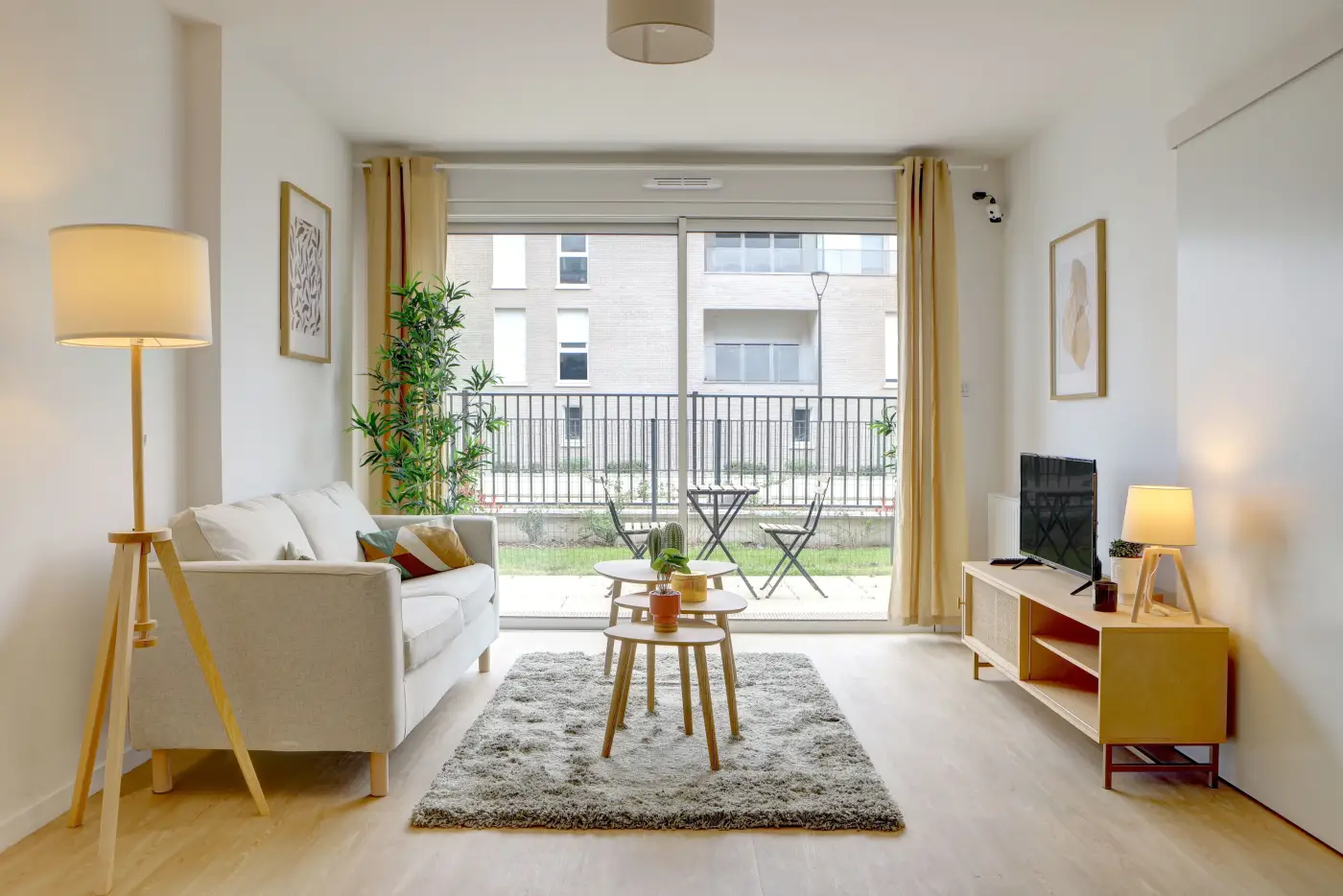 Séjour d'un appartement Mobicap avec canapé, table basse et large baie vitrée
