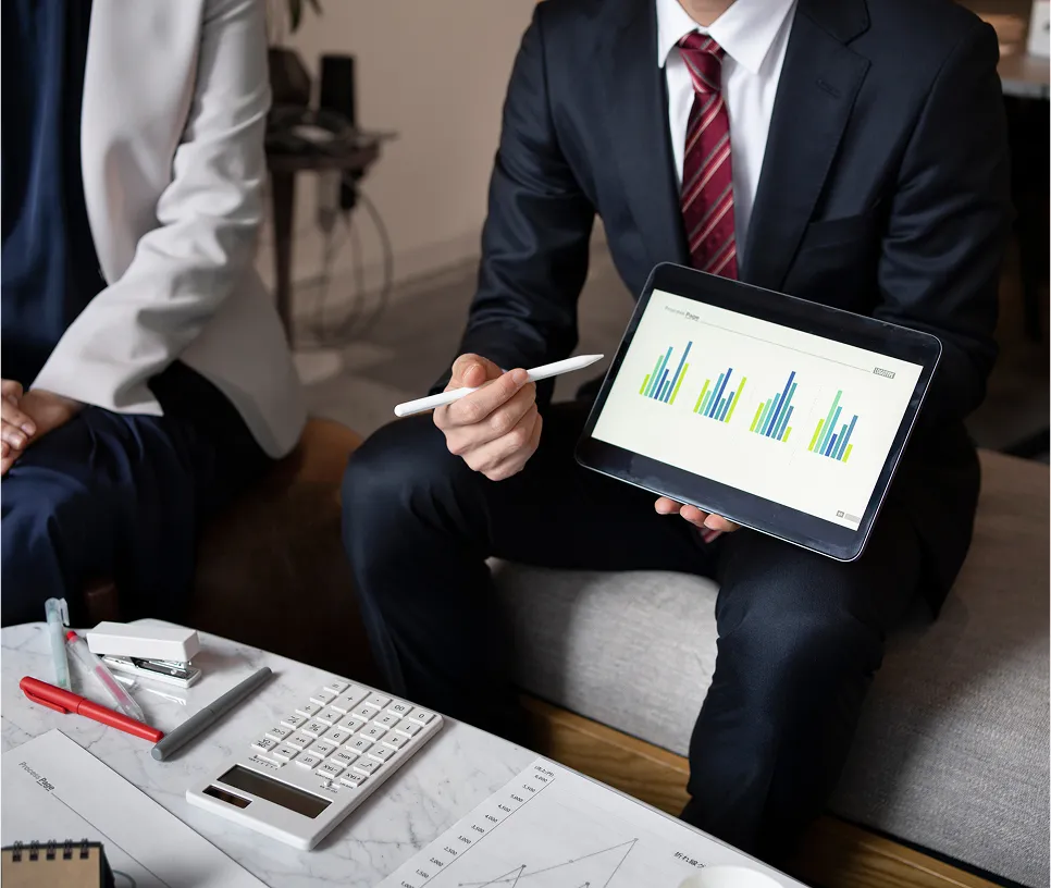 Business partners analyzing financial growth charts – Gallagher Industries