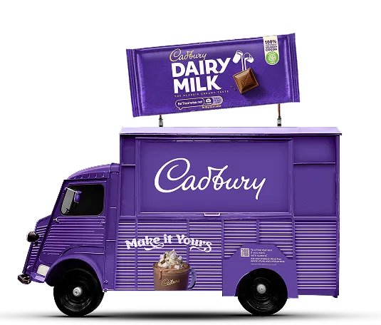 A purple truck with a sign that says Cadbury.