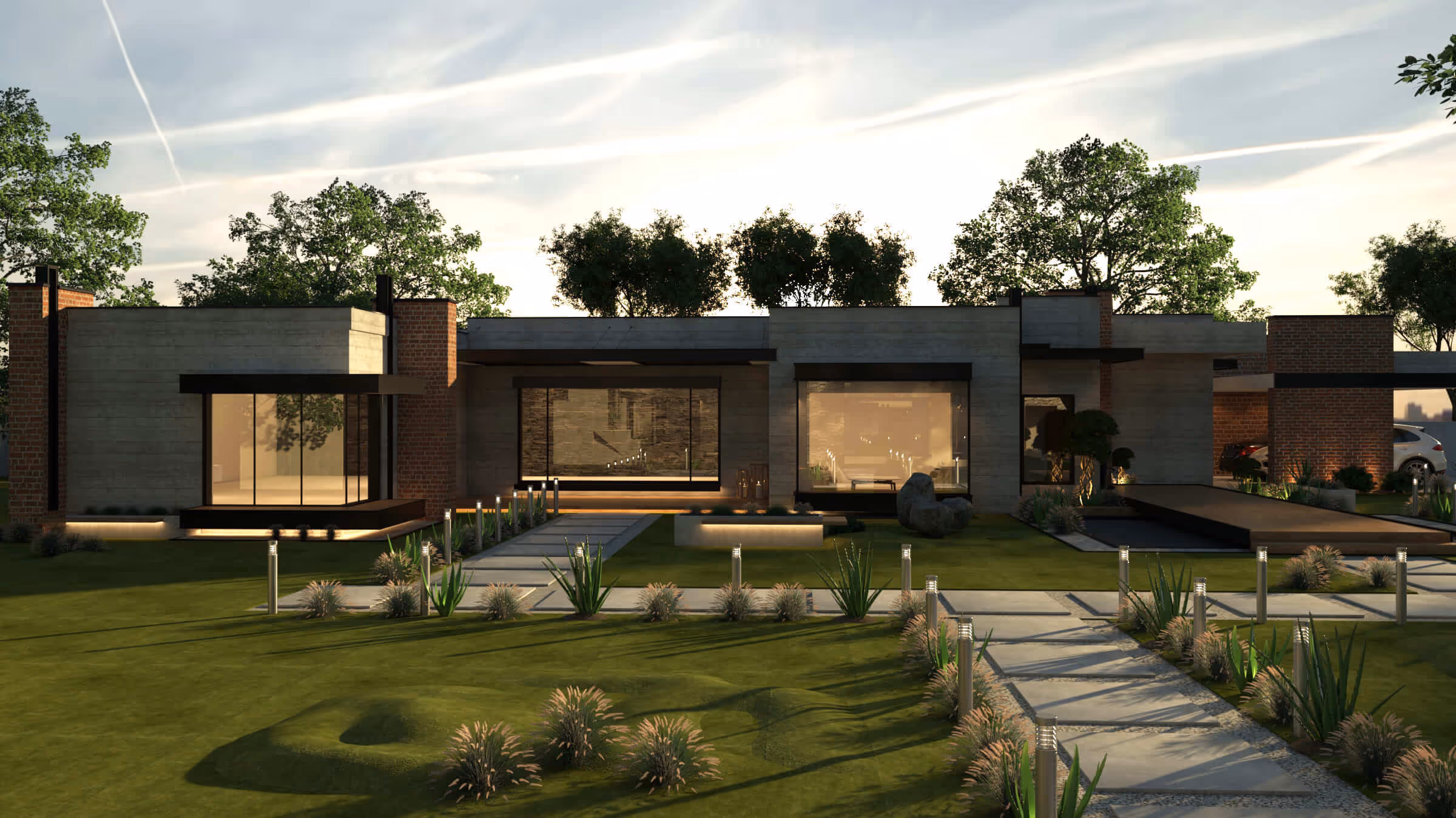 Modern single-story house with large windows, brick and concrete walls, surrounded by a well-lit landscaped garden and a paved walkway.