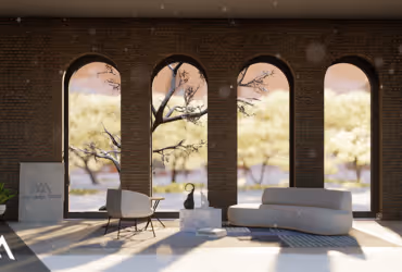 Modern lounge area with a white sofa, armchair, and a statue, set against large arched windows overlooking sunlit trees.