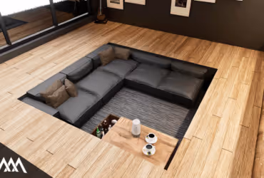 Sunken modern living room sofa with gray cushions and brown pillows surrounded by wooden flooring.