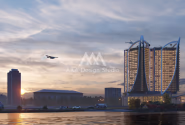 Modern high-rise tower with curved design alongside a body of water at sunset with a drone flying nearby.
