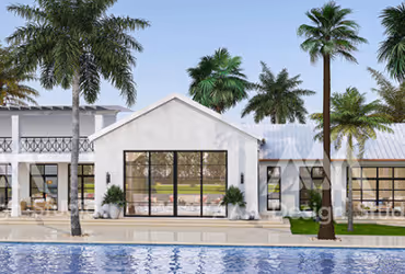 Modern white house with large glass windows facing a swimming pool, surrounded by palm trees.