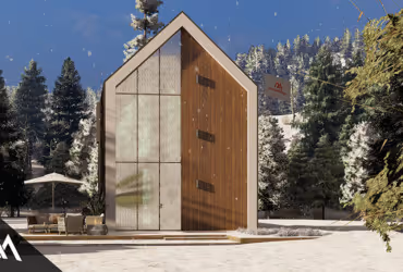 Modern A-frame cabin with wooden and glass façade surrounded by snowy forest and outdoor seating area.