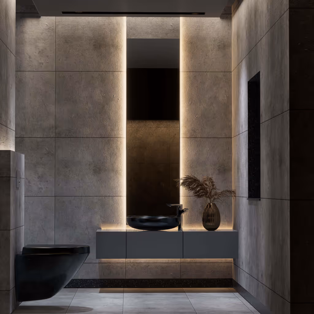 Modern bathroom with gray tiled walls, a black wall-mounted toilet, a floating vanity with black vessel sink, illuminated mirror, and a decorative vase with dried plants.