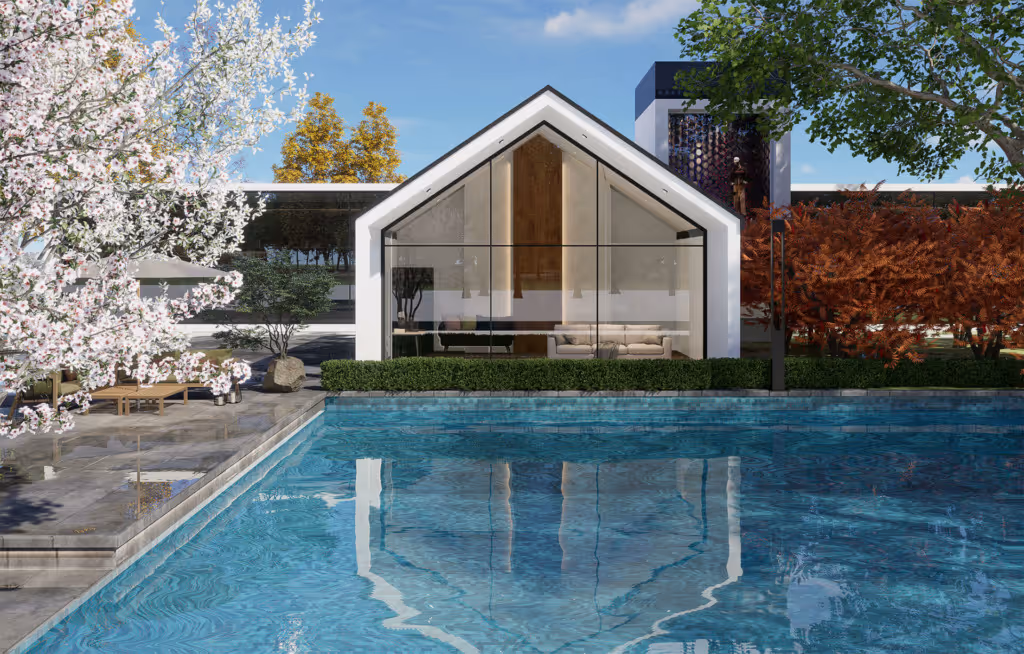 Modern house with a large glass facade reflecting in a blue swimming pool surrounded by trees with white and orange foliage.