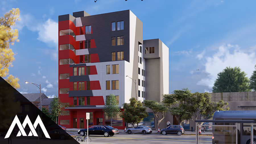 Modern multi-story building with red, white, and dark gray facade next to a street with parked cars and trees under a blue sky.