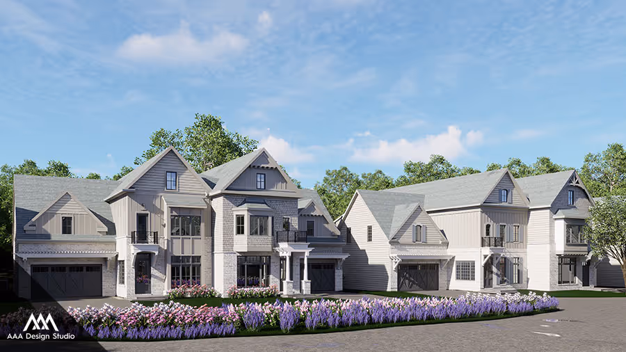 Modern two-story houses with light gray siding and stone accents, surrounded by green trees and purple flowers along the driveway.