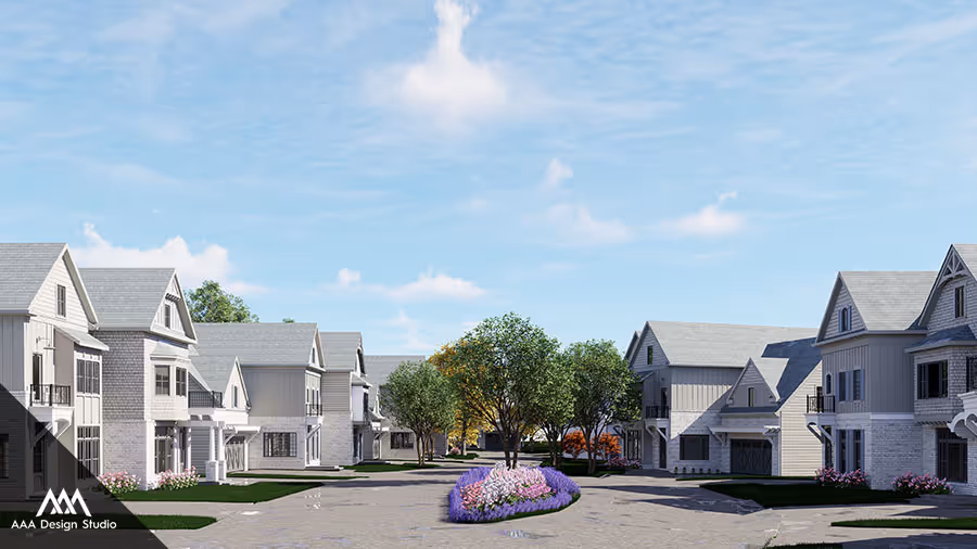 Modern suburban street with rows of gray and white houses, green trees, and a flower bed in the center under a blue sky.