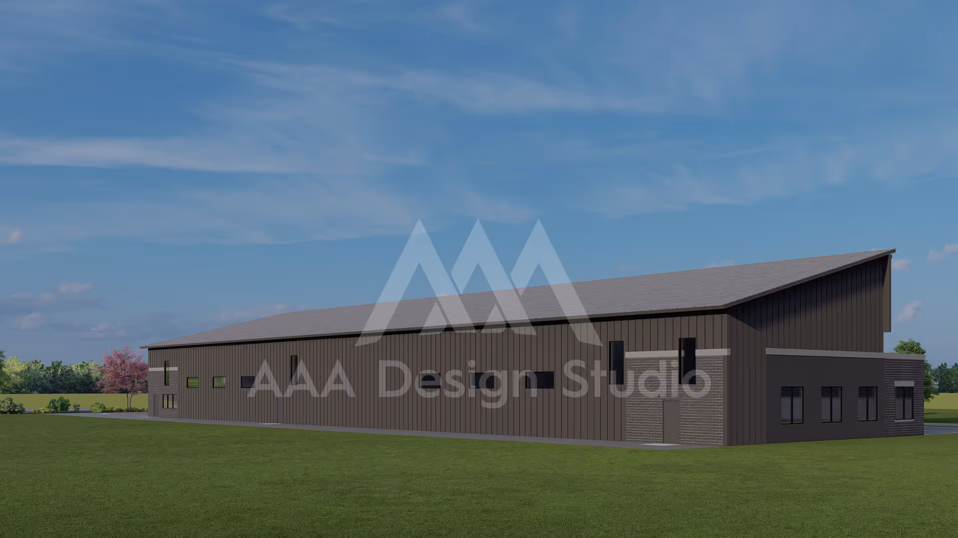 Modern industrial building with dark vertical siding and a sloped roof, surrounded by grass and trees under a blue sky.