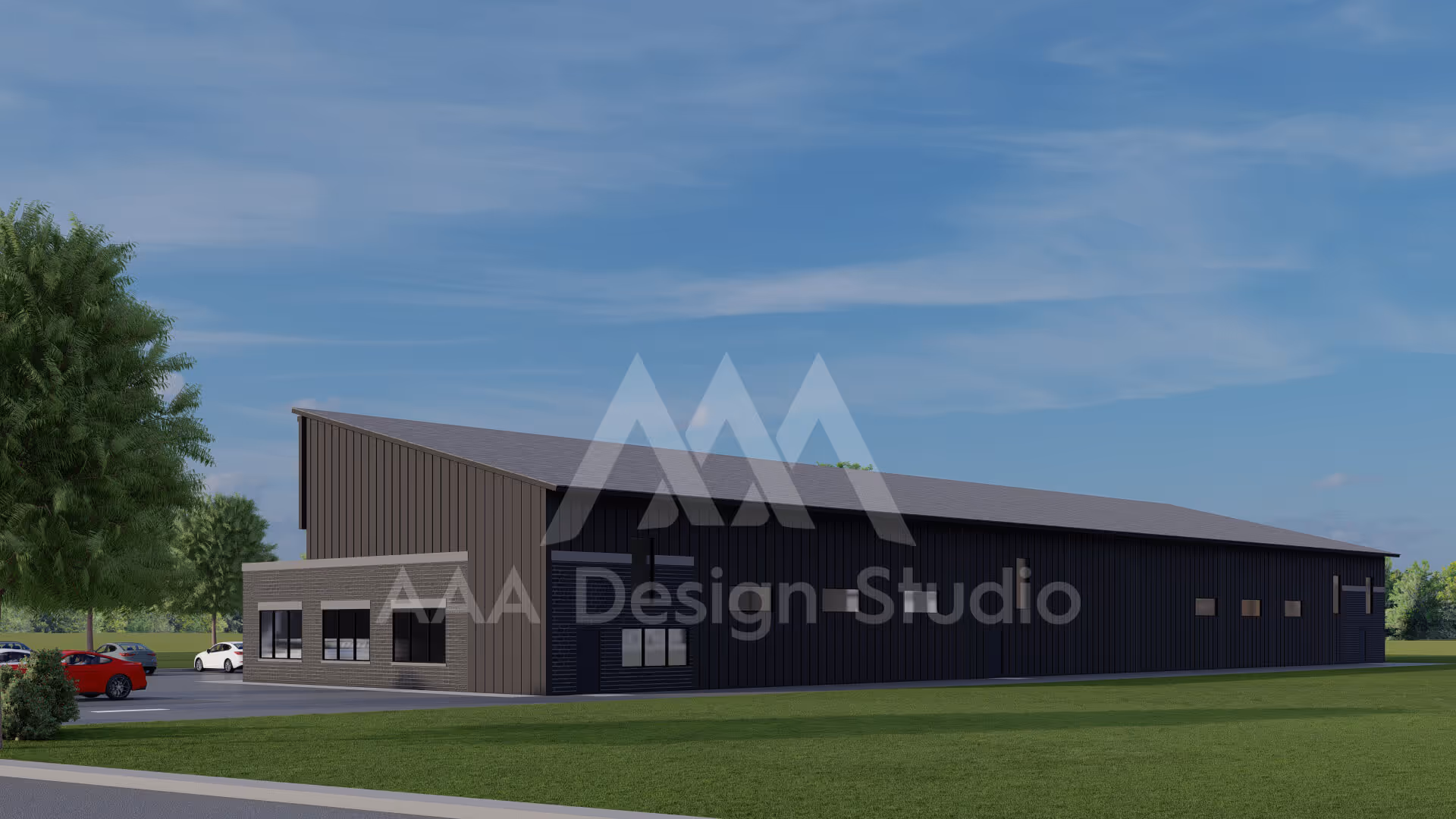 Modern dark-colored industrial building with a smaller attached brick office section and adjacent parking lot with cars.