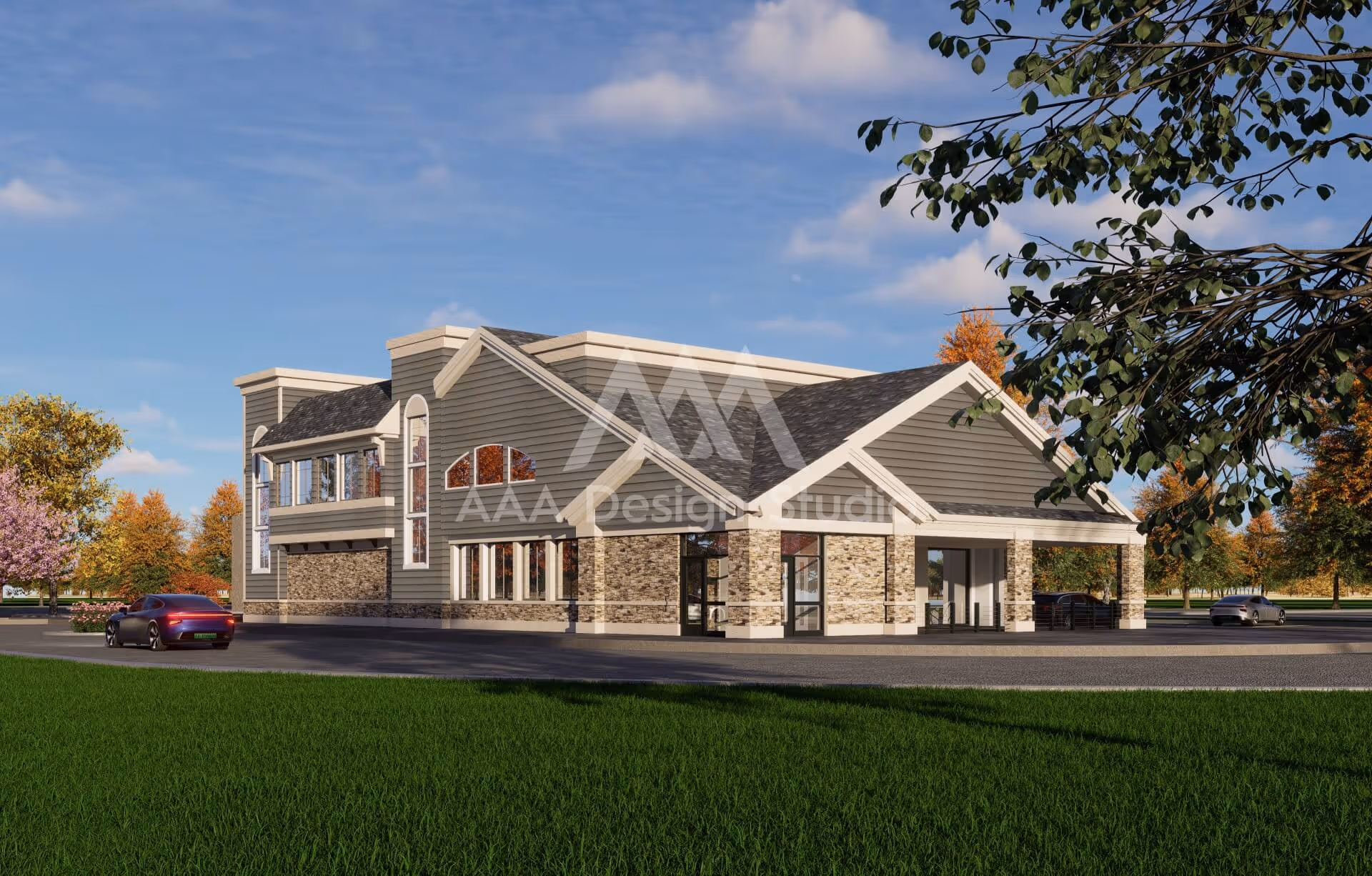Modern two-story building with stone and siding exterior surrounded by green grass and autumn trees under a blue sky.