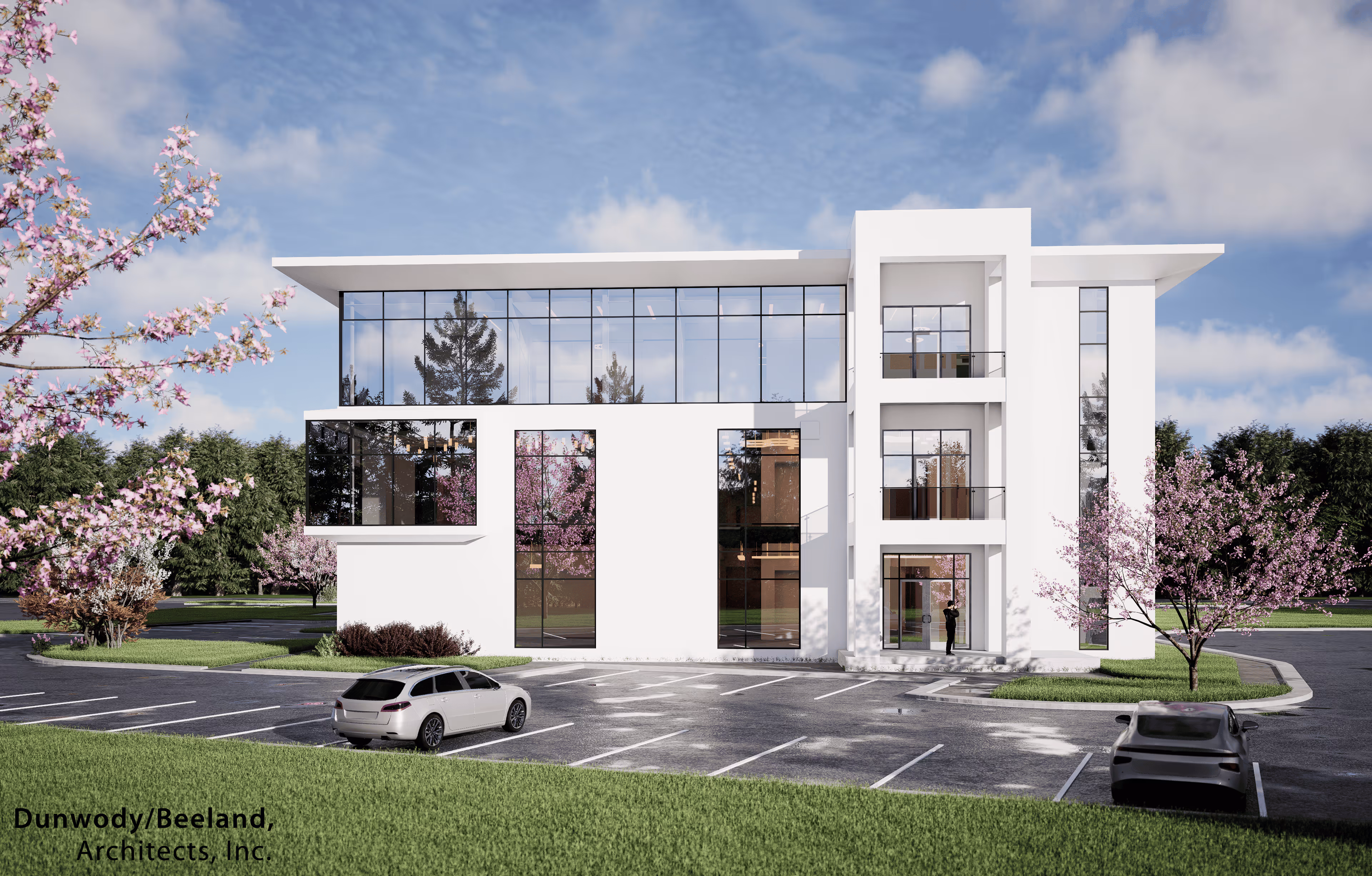 Modern three-story white office building with large glass windows, surrounded by cherry blossom trees and parked cars under a blue sky.
