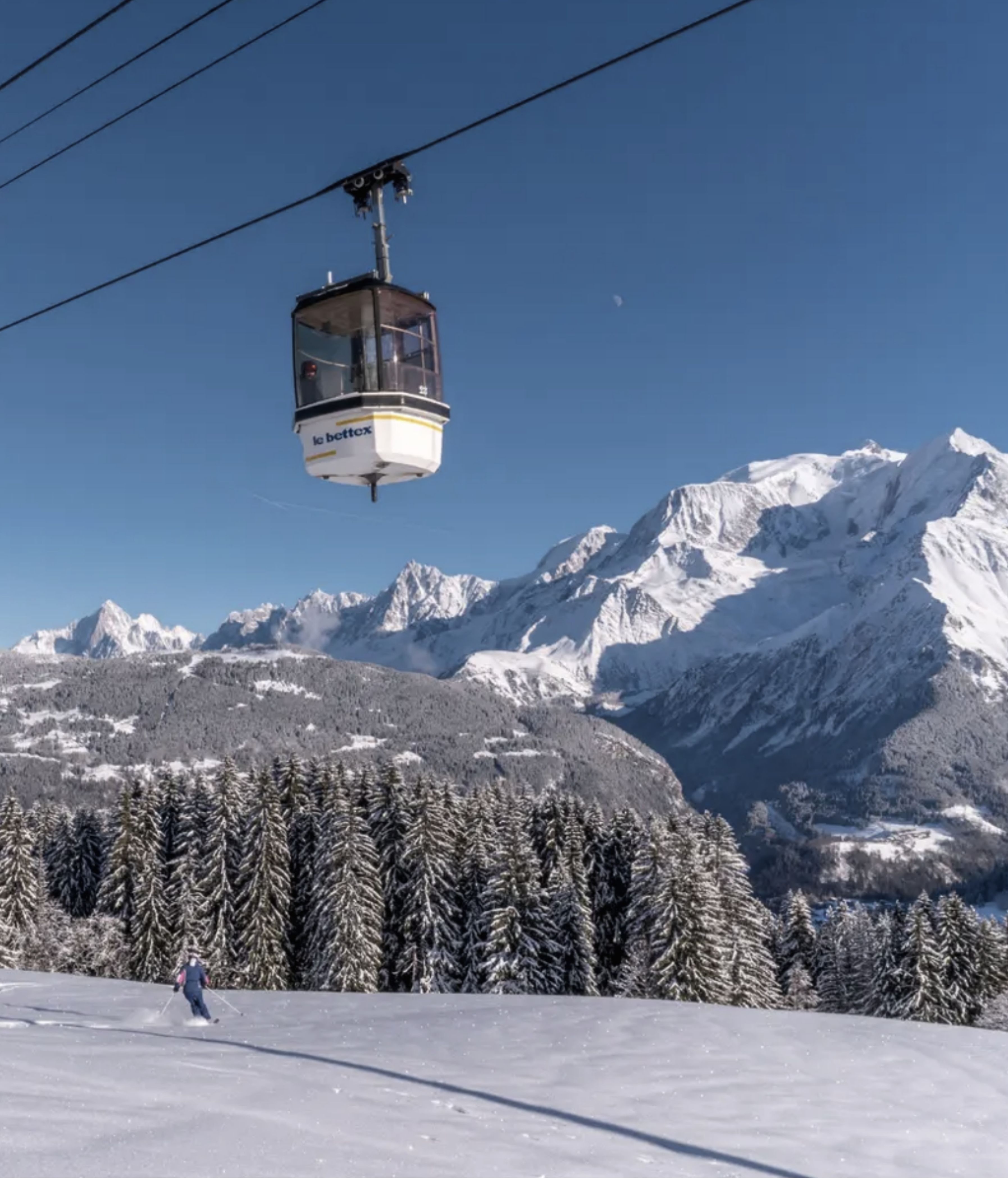 Gondola lift flying over the snowy mountains in Megève.