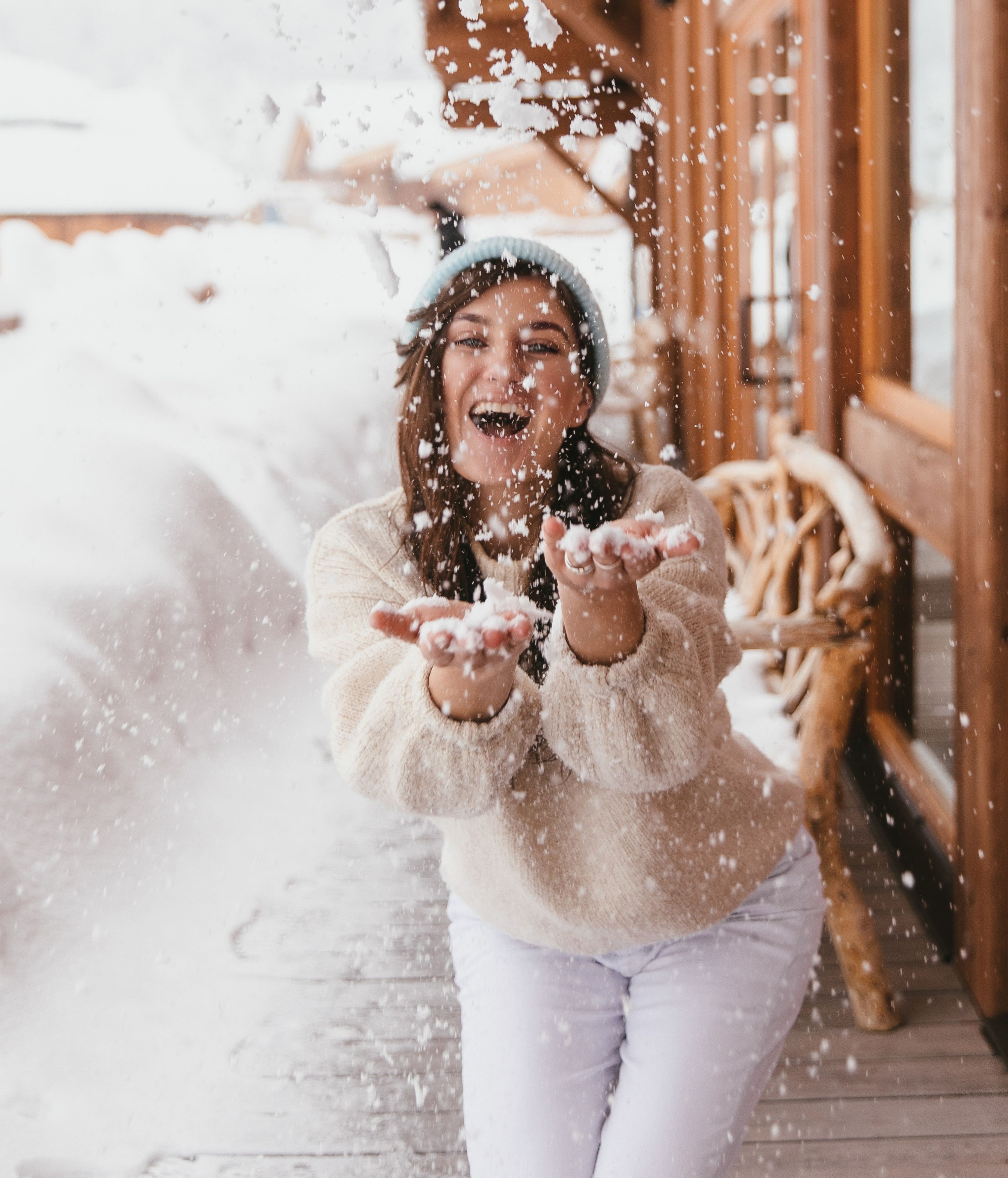 Smiling woman holding a hot drink in a chalet at the Refuge Chez La Tante — Megève.
