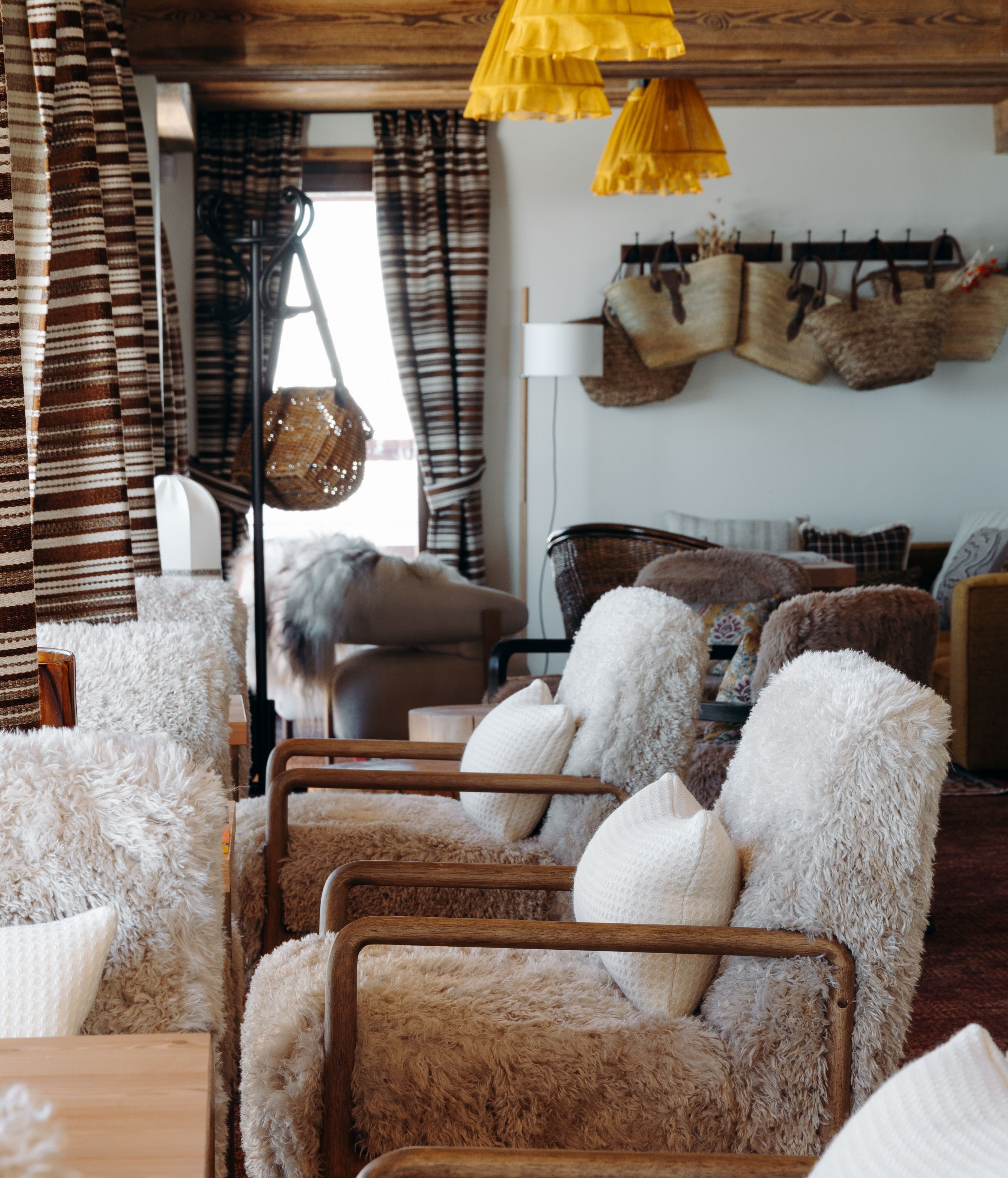 Woman enjoying a meal overlooking the snowy mountains at the Refuge Chez La Tante — Megève.