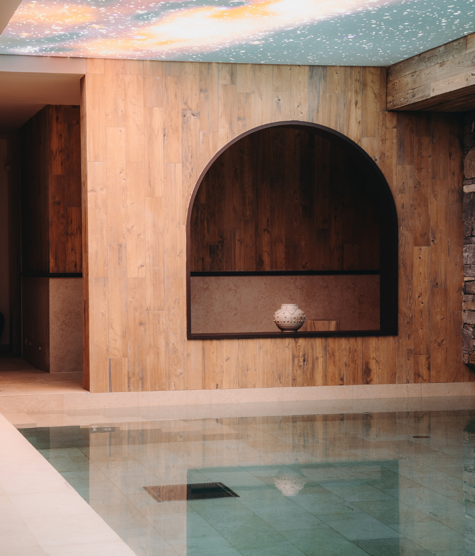 Refined dining room with stone arches and soft lighting at the Refuge Chez La Tante — Megève.