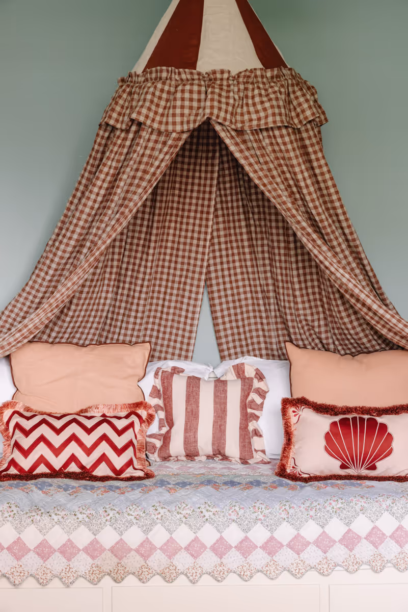 Preview of the Jones' Nursery project. A playful, textured canopy hangs over a daybed with bespoke embroidered cushions.