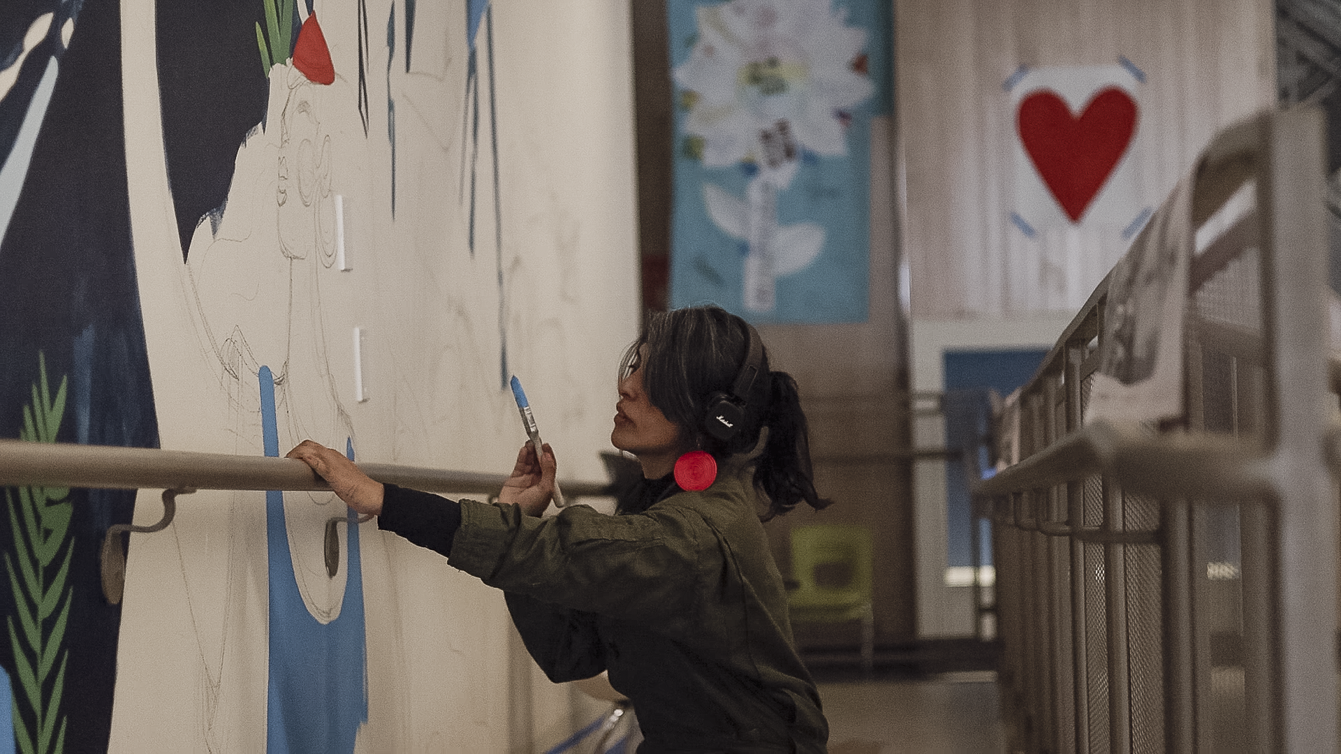 Artist Pame Chévez painting mural