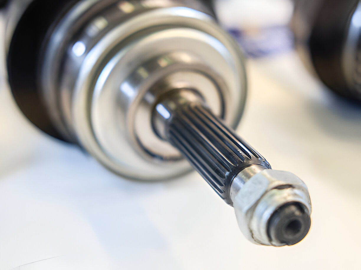 Close-up of a metallic industrial shaft or axle with ribbed surface