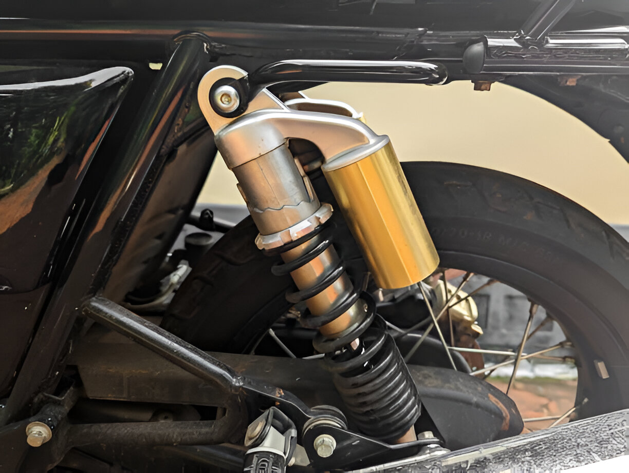 Motorcycle shock absorber with yellow and silver suspension on black frame