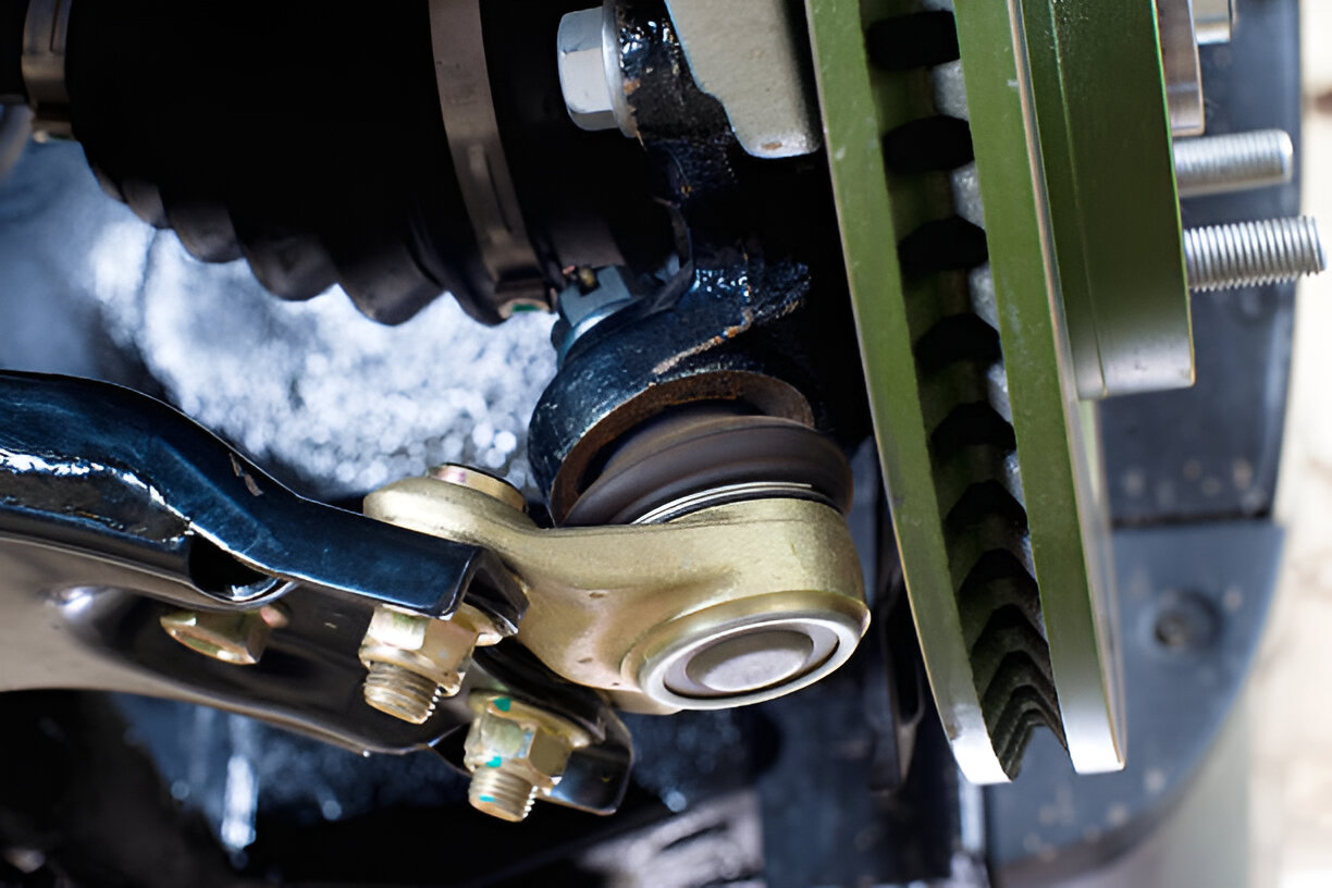 Close-up of mechanical joint with bolts, gears, and metallic components