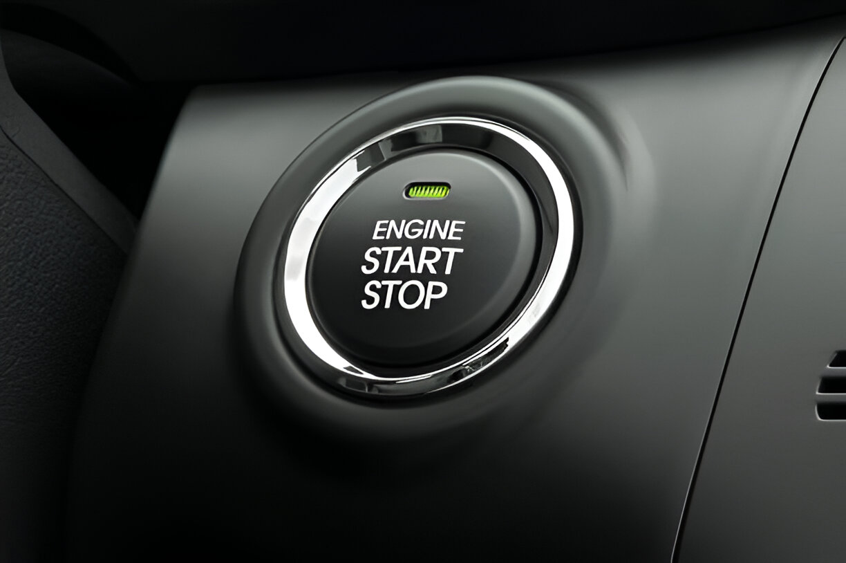 Close-up of car dashboard with illuminated engine start-stop button